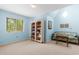 Comfortable bonus room with a floral sofa, bookshelves and natural light at 966 Waterway Ln., Myrtle Beach, SC 29572