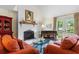 Cozy living room featuring fireplace with brick surround and charming decor at 966 Waterway Ln., Myrtle Beach, SC 29572