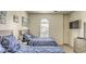 Comfortable nautical-themed bedroom with two beds, dresser, tv, and arched windows for natural light at 9780 Leyland Dr. # 112, Myrtle Beach, SC 29572