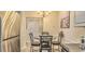 Cozy dining area features a charming table set with chairs and stainless steel refrigerator at 9780 Leyland Dr. # 112, Myrtle Beach, SC 29572