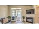 Open living room showcasing a fireplace and access to a sunroom with ample natural light at 9780 Leyland Dr. # 112, Myrtle Beach, SC 29572
