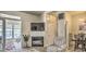 Cozy living room with fireplace, access to sunroom, and dining area with stylish chandelier at 9780 Leyland Dr. # 112, Myrtle Beach, SC 29572
