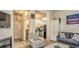 Bright living room with fireplace and striped chair, seamlessly connecting to the kitchen area at 9780 Leyland Dr. # 112, Myrtle Beach, SC 29572