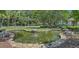 Scenic pond featuring a stone border, water features, and lush landscaping at 9780 Leyland Dr. # 112, Myrtle Beach, SC 29572
