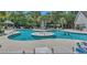 Inviting community pool with a central fountain feature, surrounded by lounge chairs and lush greenery at 9780 Leyland Dr. # 112, Myrtle Beach, SC 29572