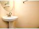 Bathroom with a pedestal sink, round mirror, and neutral-colored wall at 990 Palisade Circle, Myrtle Beach, SC 29577