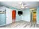 Spacious bedroom with wood-look flooring, ceiling fan, and an ensuite bathroom at 990 Palisade Circle, Myrtle Beach, SC 29577