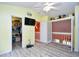 Upstairs bedroom with gray floors, closet and loft access, and ceiling fan at 990 Palisade Circle, Myrtle Beach, SC 29577