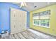 Bright bedroom featuring a built-in Murphy bed, wood-look floors, and colorful accent walls, complemented by a window at 990 Palisade Circle, Myrtle Beach, SC 29577