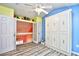 Bright bedroom featuring a built-in Murphy bed, wood-look floors, and colorful accent walls, with access to loft space at 990 Palisade Circle, Myrtle Beach, SC 29577