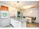 Modern kitchen island with granite countertop, white cabinets, and stylish pendant lighting at 990 Palisade Circle, Myrtle Beach, SC 29577