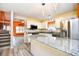 Bright kitchen with white cabinetry, stainless steel appliances, and granite island overlooking living area at 990 Palisade Circle, Myrtle Beach, SC 29577