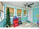 Bright sunroom featuring tile floors, neutral blinds, ceiling fan, and a white door at 990 Palisade Circle, Myrtle Beach, SC 29577