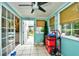 Bright sunroom featuring tile floors, neutral blinds, ceiling fan, and access to the patio at 990 Palisade Circle, Myrtle Beach, SC 29577