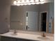 Bathroom featuring a double sink vanity with a large mirror and modern fixtures at Tbd Aft Ct # 101, Murrells Inlet, SC 29576