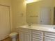 A bathroom featuring a double vanity, toilet, and a linen closet, offering ample storage at Tbd Aft Ct # 101, Murrells Inlet, SC 29576