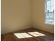 This bedroom features hardwood floors and a large window, creating a sunny and inviting space at Tbd Aft Ct # 101, Murrells Inlet, SC 29576