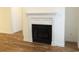 Living room featuring a white fireplace, hardwood floors, and light yellow walls at Tbd Aft Ct # 101, Murrells Inlet, SC 29576
