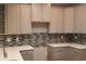 Stylish kitchen featuring gray cabinets, quartz countertops, and designer backsplash at Tbd Aft Ct # 101, Murrells Inlet, SC 29576