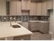 Well-lit kitchen with gray cabinets, quartz countertops, and stainless steel sink at Tbd Aft Ct # 101, Murrells Inlet, SC 29576