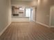 Open-concept living area with wood floors, connecting seamlessly to the kitchen and entryway at Tbd Aft Ct # 101, Murrells Inlet, SC 29576