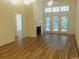 Open-concept living room with hardwood floors, fireplace, and French doors, perfect for entertaining at Tbd Aft Ct # 101, Murrells Inlet, SC 29576