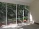 Enclosed porch featuring an outside view of lush greenery and a sunny concrete floor at Tbd Aft Ct # 101, Murrells Inlet, SC 29576
