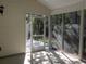 Enclosed porch featuring an outside view of lush greenery and a sunny concrete floor at Tbd Aft Ct # 101, Murrells Inlet, SC 29576