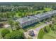 An aerial of the condos showcasing well-manicured grounds, a pond, and a golf course at 1001 World Tour Blvd. # 203, Myrtle Beach, SC 29579