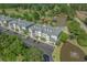 Aerial view of a condo complex by a pond and golf course, surrounded by lush trees at 1001 World Tour Blvd. # 203, Myrtle Beach, SC 29579