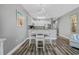 Dining area adjacent to the kitchen, featuring modern lighting and stylish seating for four at 1001 World Tour Blvd. # 203, Myrtle Beach, SC 29579