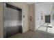 Hallway with elevator, fire extinguisher, and access to the exterior walkway and building exit at 1001 World Tour Blvd. # 203, Myrtle Beach, SC 29579