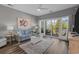 Comfortable living room with a ceiling fan, large window to the balcony, and stylish furniture at 1001 World Tour Blvd. # 203, Myrtle Beach, SC 29579