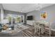 Bright and airy living room with a ceiling fan and balcony access overlooking a serene pond at 1001 World Tour Blvd. # 203, Myrtle Beach, SC 29579