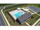 An aerial view of the community pool area with a pergola, bath house, ample lounging and fenced perimeter at 1009 Garden Sprout Dr, Galivants Ferry, SC 29544