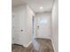 Bright hallway features a front door with glass and wood-look flooring at 1009 Garden Sprout Dr, Galivants Ferry, SC 29544