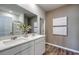 Stylish bathroom with double sinks, white cabinets, quartz countertop, decorative wall art and wood flooring at 1014 Laconic Dr., Myrtle Beach, SC 29588