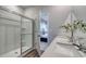 Clean bathroom featuring a shower, double sinks, quartz countertop, white cabinets and an open view to the bedroom at 1014 Laconic Dr., Myrtle Beach, SC 29588