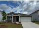 Charming single-Gathering home featuring a two-car garage and manicured front yard at 1014 Laconic Dr., Myrtle Beach, SC 29588