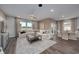 Open living space with a comfortable white sectional sofa, wood floors, a dining area and lots of natural light at 1014 Laconic Dr., Myrtle Beach, SC 29588