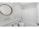 Bathroom with a wooden framed mirror, white cabinets, and a combined shower and tub at 1015 Elm St. # 4, Conway, SC 29526