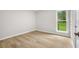 Empty bedroom featuring neutral paint, light wood floors, and a bright window at 1015 Elm St. # 4, Conway, SC 29526
