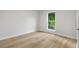 Bright bedroom featuring neutral paint, light wood floors, and a window with a green view at 1015 Elm St. # 4, Conway, SC 29526