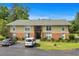 Apartment building featuring brick and beige siding, complemented by lush landscaping at 1015 Elm St. # 4, Conway, SC 29526