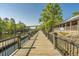 A long wooden boardwalk with black railings that goes out on the water in a riverfront community at 1015 Elm St. # 4, Conway, SC 29526