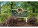 Oak Hill Condominiums sign, located at 1015 Elm Street, surrounded by plants at 1015 Elm St. # 4, Conway, SC 29526