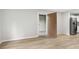 Open living room featuring neutral paint, light wood floors, and an open doorway at 1015 Elm St. # 4, Conway, SC 29526