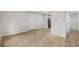 Spacious room with wood-look floors leading to a doorway and view of the kitchen appliances at 1015 Elm St. # 4, Conway, SC 29526