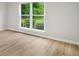 A bright living area featuring durable wood floors and natural light streaming through a large window at 1015 Elm St. # 4, Conway, SC 29526