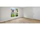 Inviting living space features wood-look flooring and a large window offering a view of the exterior at 1015 Elm St. # 4, Conway, SC 29526